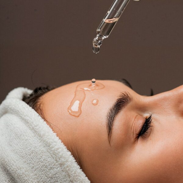 Applying serum forehead skincare treatment 2000px 600x600